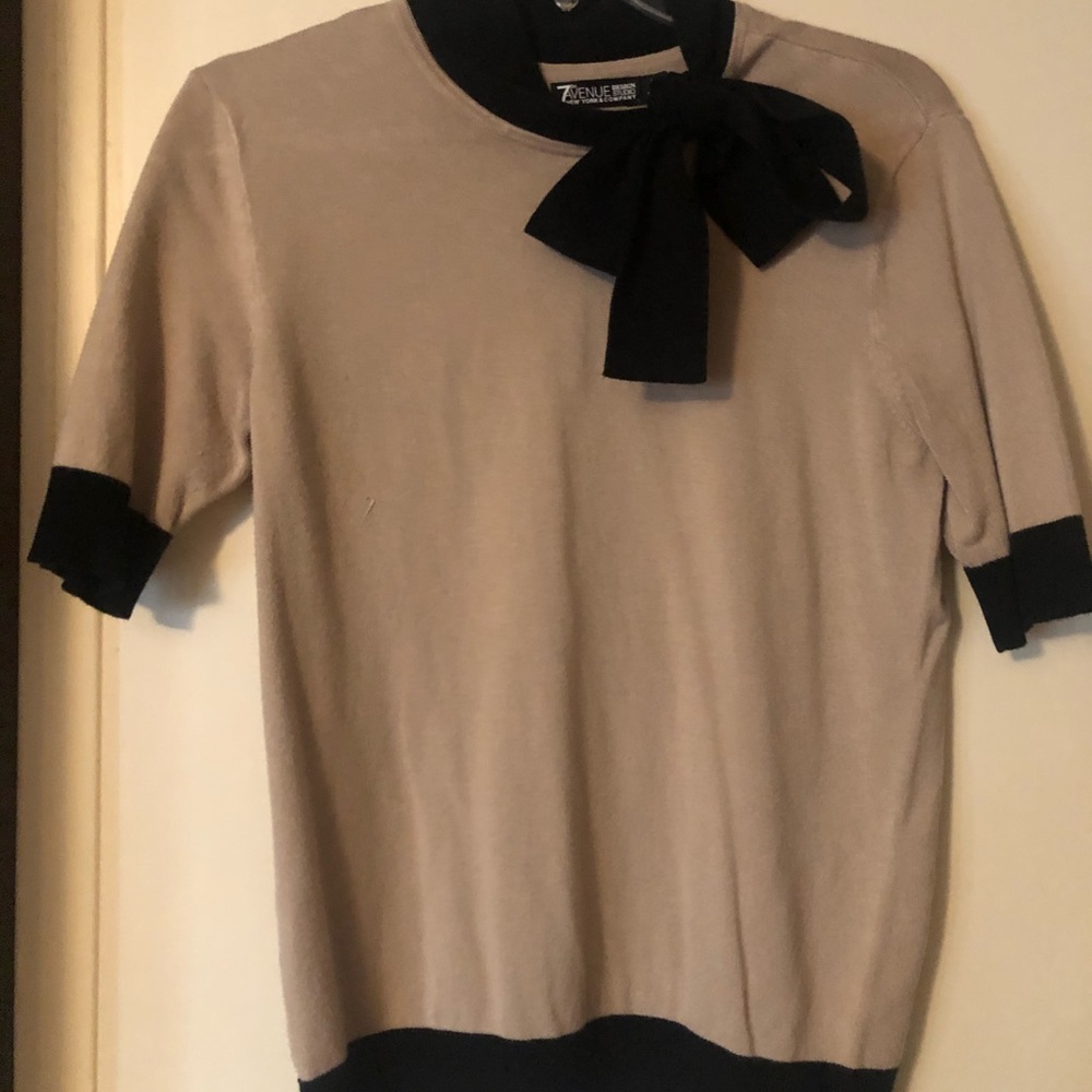 Beige and black knit top with bow neckline